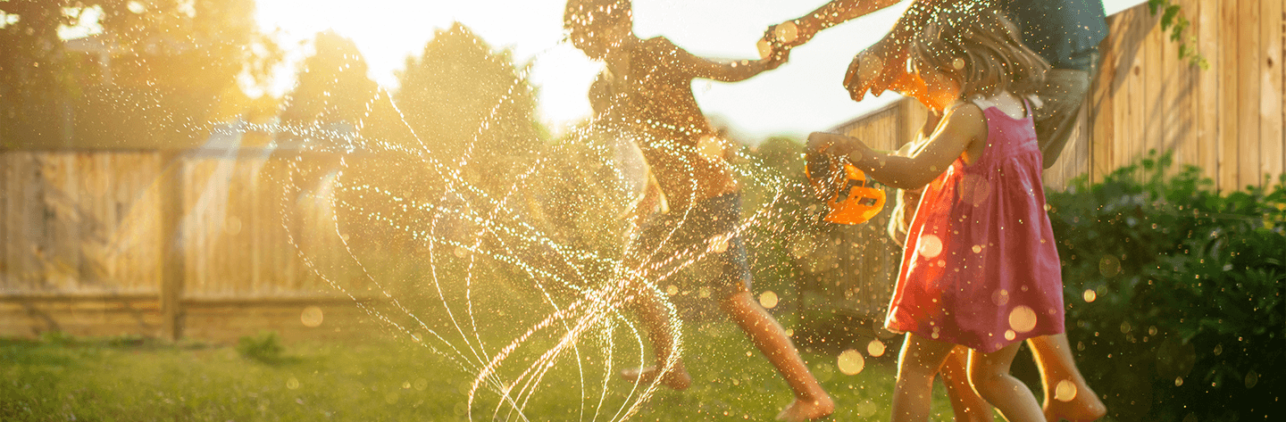 Kids playing sprinkler